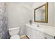 Bright bathroom featuring a single sink vanity, decorative mirror, and patterned shower curtain at 4215 Homestead Ridge Dr, Cumming, GA 30041