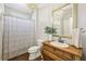 Bathroom vanity with framed mirror and decorative chandelier and shower with patterned curtain at 4215 Homestead Ridge Dr, Cumming, GA 30041