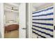 Bathroom with blue striped shower curtain and a glimpse into the cozy bedroom at 4215 Homestead Ridge Dr, Cumming, GA 30041