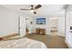 Bedroom with a TV, wood desk, and doors leading to a bathroom and exterior access at 4215 Homestead Ridge Dr, Cumming, GA 30041