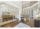 Open dining room features wood floors, a large table, and a chandelier, with views to other living areas at 4215 Homestead Ridge Dr, Cumming, GA 30041