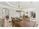 Well-lit dining room with wood floors, an elegant chandelier, and views to other living spaces at 4215 Homestead Ridge Dr, Cumming, GA 30041