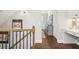 Upstairs hallway featuring wood floors, a built-in desk, and stylish decor at 4215 Homestead Ridge Dr, Cumming, GA 30041