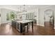 Kitchen features an island with wine cooler, cooktop, and decorative pendant lights at 4215 Homestead Ridge Dr, Cumming, GA 30041