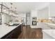 Spacious kitchen features white cabinets, stainless steel appliances, and a large island with seating at 4215 Homestead Ridge Dr, Cumming, GA 30041