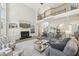 Bright, open living room with fireplace, soaring ceilings, and a staircase to the second floor overlook at 4215 Homestead Ridge Dr, Cumming, GA 30041