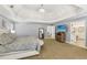 Bright main bedroom featuring carpeted floors, ensuite bathroom, and large windows at 4215 Homestead Ridge Dr, Cumming, GA 30041