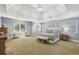 Spacious main bedroom with tray ceiling, carpet, and ensuite bathroom at 4215 Homestead Ridge Dr, Cumming, GA 30041