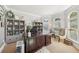 Bright office with custom desk, shelving, and natural light at 4215 Homestead Ridge Dr, Cumming, GA 30041