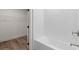 Clean bathroom showing a tub with tiled walls adjacent to a walk-in closet at 108 Park Place Unit 104, Decatur, GA 30030