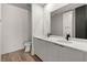 Modern bathroom features dual sinks, sleek white cabinetry, and matte black hardware at 108 Park Place Unit 104, Decatur, GA 30030