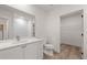 Bathroom featuring white vanity with storage and entry to walk-in closet at 108 Park Place Unit 104, Decatur, GA 30030
