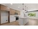 View of a modern open concept kitchen with white cabinets, island and stainless steel appliances at 108 Park Place Unit 104, Decatur, GA 30030