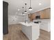 Modern kitchen with stainless appliances, subway tile backsplash, and a large island with pendant lighting at 108 Park Place Unit 104, Decatur, GA 30030