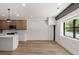 Open concept living and kitchen area with hardwood floors and modern kitchen appliances at 108 Park Place Unit 104, Decatur, GA 30030