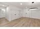 Living room with hardwood floors, neutral paint, and modern light fixture at 108 Park Place Unit 104, Decatur, GA 30030