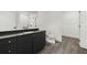 This bathroom has a walk in shower, gray cabinet, and toilet at 108 Park Place Unit 304, Decatur, GA 30030