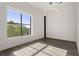 Sunny bedroom features hardwood floors, a large window, and a modern lighting fixture at 108 Park Place Unit 304, Decatur, GA 30030