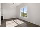Sunlit living room with hardwood floors, large window, and modern lighting fixture at 108 Park Place Unit 304, Decatur, GA 30030