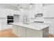 Well-appointed kitchen with an island, white cabinets, stainless steel appliances, and modern fixtures at 2572 Silver Star Ne Dr, Marietta, GA 30066