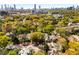 Stunning aerial shot of homes nestled among vibrant trees, with a cityscape backdrop on a clear day at 637 Linwood Ne Ave, Atlanta, GA 30306