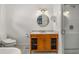 Well-lit bathroom with marble counters, wooden vanity, and walk-in shower at 637 Linwood Ne Ave, Atlanta, GA 30306