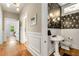 Stylish half-bath with balloon wallpaper, pedestal sink, and wood floors at 637 Linwood Ne Ave, Atlanta, GA 30306