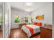 Bright bedroom with hardwood floors, a cozy desk, and large windows framing a lush outdoor view at 637 Linwood Ne Ave, Atlanta, GA 30306
