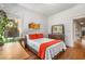 Bright bedroom with hardwood floors, desk, artwork, and a mirror at 637 Linwood Ne Ave, Atlanta, GA 30306