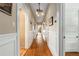 Long hallway with hardwood floors, white trim, and elegant lighting fixtures at 637 Linwood Ne Ave, Atlanta, GA 30306