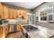 Kitchen island featuring a gas cooktop, granite countertops and natural wood cabinets at 637 Linwood Ne Ave, Atlanta, GA 30306