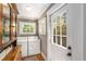 Bright laundry room with washer, dryer, white cabinets, and natural light at 637 Linwood Ne Ave, Atlanta, GA 30306