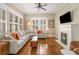 Cozy living room with fireplace, hardwood floors, and large windows with shutters at 637 Linwood Ne Ave, Atlanta, GA 30306