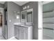 Bathroom features a modern vanity, decorative mirror, and view into storage closet at 6691 Colchester Pl, Norcross, GA 30093