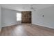 Bright bedroom featuring hardwood floors, a ceiling fan, and a distinctive stone wall at 6691 Colchester Pl, Norcross, GA 30093