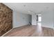 Spacious bedroom featuring a decorative stone wall and sleek modern flooring at 6691 Colchester Pl, Norcross, GA 30093