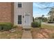 Inviting townhouse featuring a light gray front door and manicured landscaping at 6691 Colchester Pl, Norcross, GA 30093