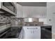Modern kitchen featuring stainless steel appliances, granite counters, and stylish backsplash at 6691 Colchester Pl, Norcross, GA 30093