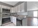 Well-lit kitchen with stainless steel appliances and easy access to living area at 6691 Colchester Pl, Norcross, GA 30093