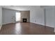 Spacious living room featuring hardwood floors and a cozy stone fireplace at 6691 Colchester Pl, Norcross, GA 30093