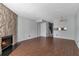 Bright living room with hardwood floors, stone fireplace, and open floor plan at 6691 Colchester Pl, Norcross, GA 30093