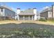 A large grass backyard with a screened in porch on the house and a small garden at 1055 Crabapple Parc Dr, Roswell, GA 30076