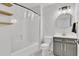 Modern bathroom with a tub-shower combination, tiled walls, a vanity, and decorative floating shelves at 1055 Crabapple Parc Dr, Roswell, GA 30076