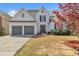 Charming two-story home with a two-car garage and a well-maintained front yard at 1055 Crabapple Parc Dr, Roswell, GA 30076