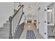 Open foyer with high ceilings, staircase, chandelier and luxury vinyl plank flooring at 1055 Crabapple Parc Dr, Roswell, GA 30076