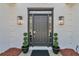 Close up of the front door with sidelights, plants and updated hardware at 1055 Crabapple Parc Dr, Roswell, GA 30076