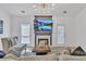 Bright living room featuring a fireplace with a TV, contemporary chandelier, and modern furnishings at 1055 Crabapple Parc Dr, Roswell, GA 30076