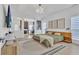 Airy main bedroom with natural wood accents, stylish lighting, and a view to a home office with a fireplace at 1055 Crabapple Parc Dr, Roswell, GA 30076