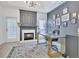 Stylish home office featuring a marble fireplace, unique decor, a modern desk, and natural light at 1055 Crabapple Parc Dr, Roswell, GA 30076
