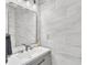 Modern powder room featuring gray vanity, mirror, and decorative stone wall at 1055 Crabapple Parc Dr, Roswell, GA 30076